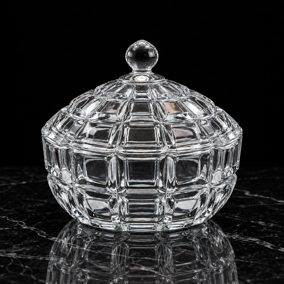 Block cut glass candy bowl on black marble