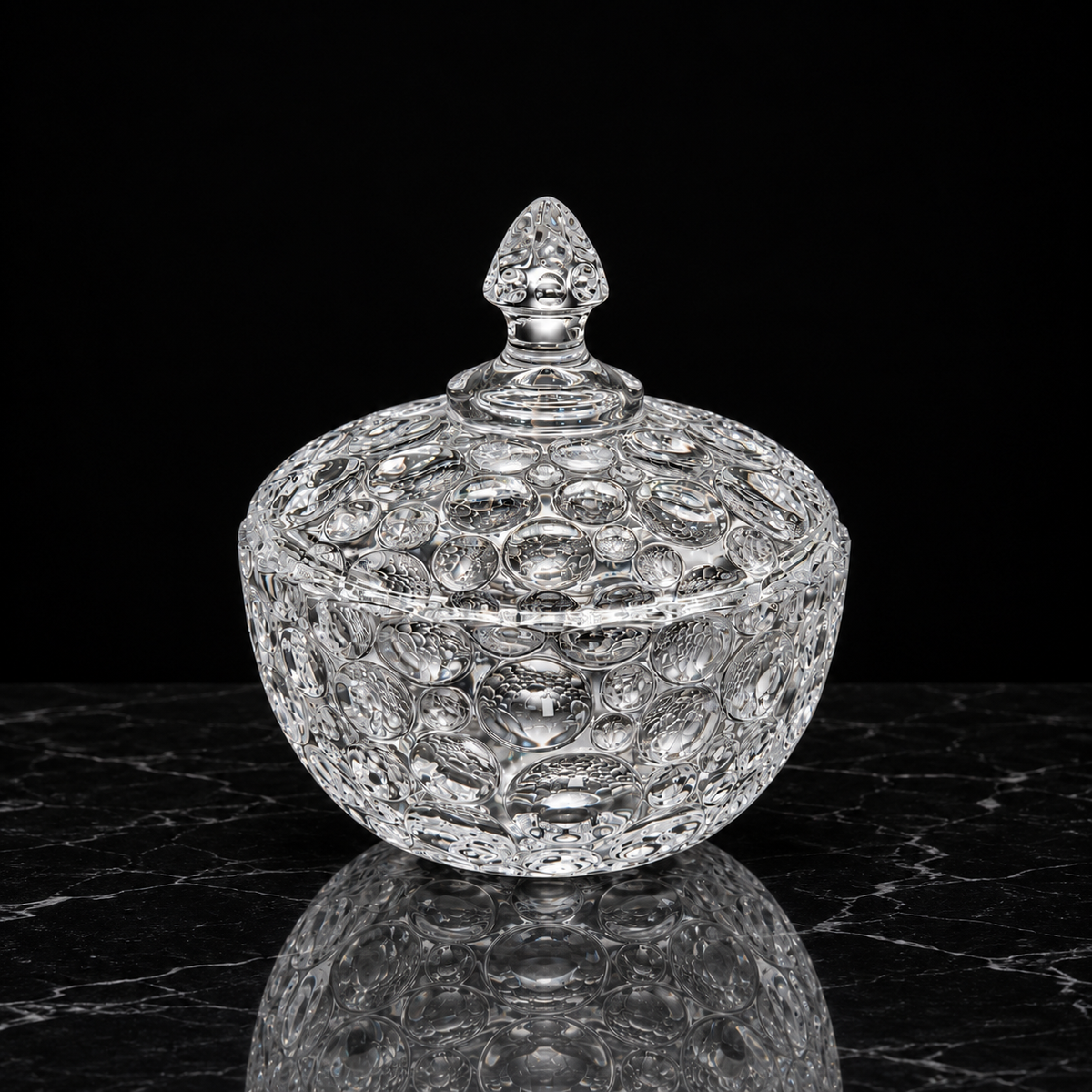 Large bubble glass candy bowl on black marble