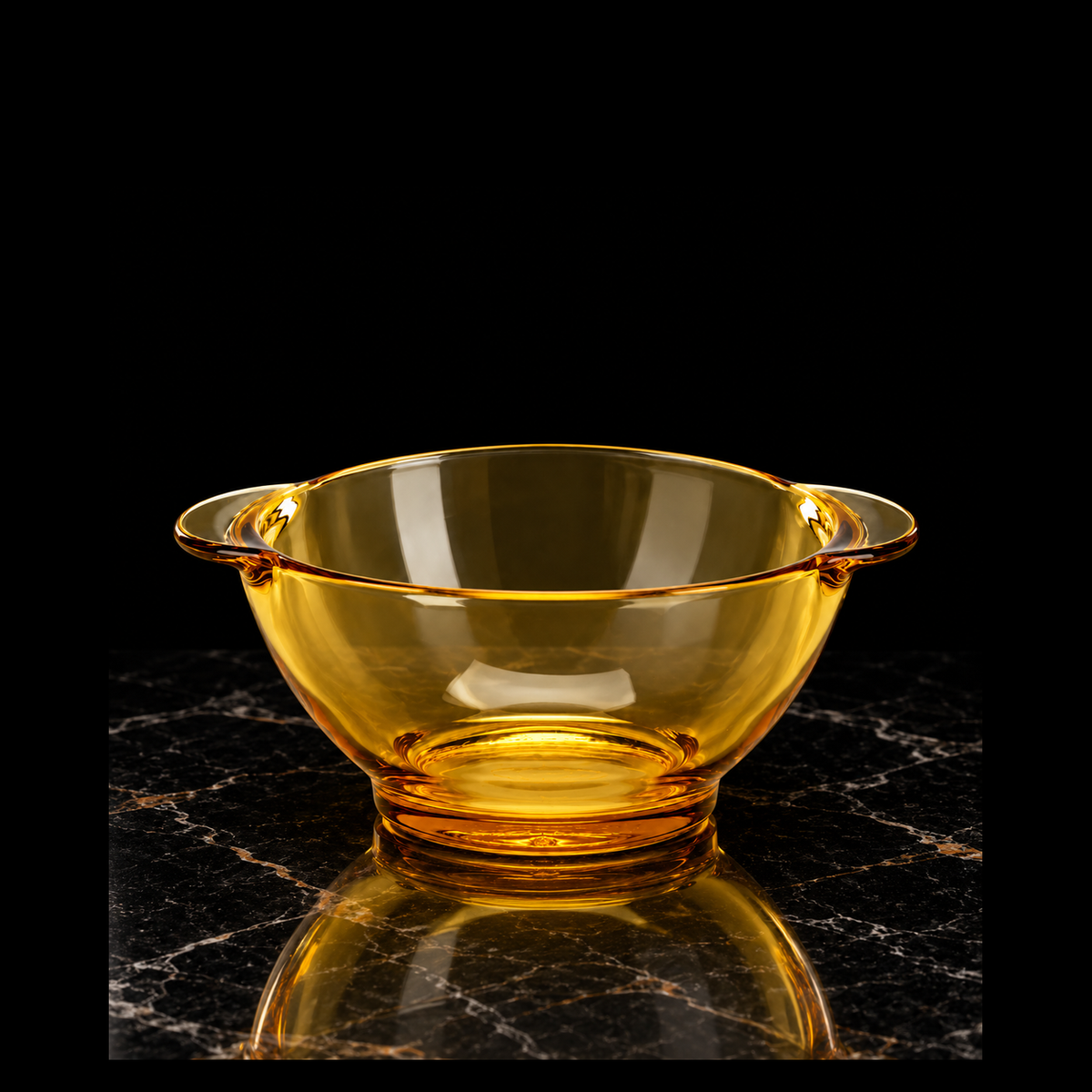 Amber glass bowl on black marble