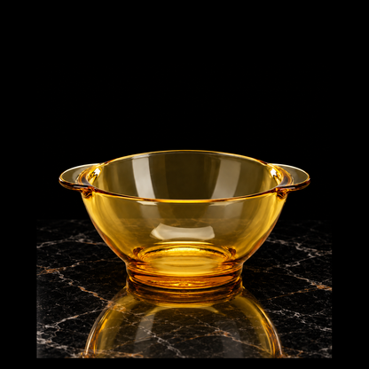 Amber glass bowl on black marble