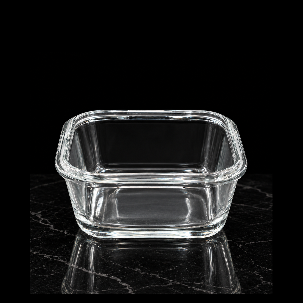 Square glass dish on black marble
