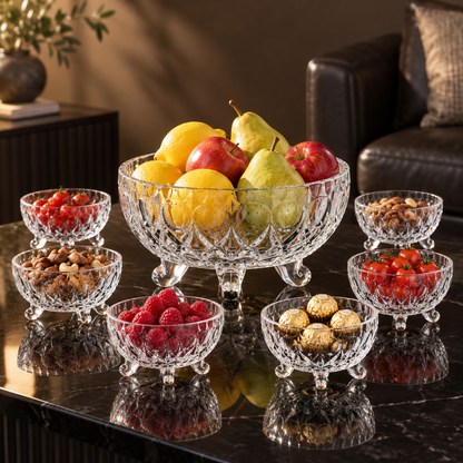 Glass bowl set with fruit, nuts, berries and chocolates