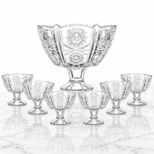 7-piece starburst-cut crystal footed bowl set on white marble
