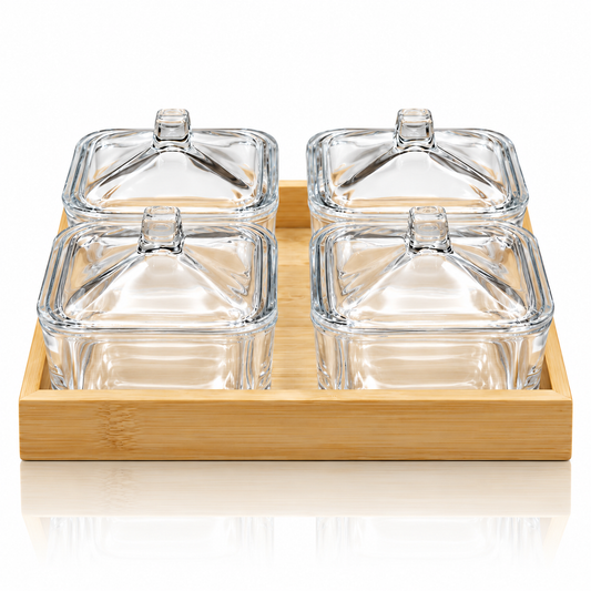 Set of 4 square glass lidded serving dishes in bamboo tray on white marble