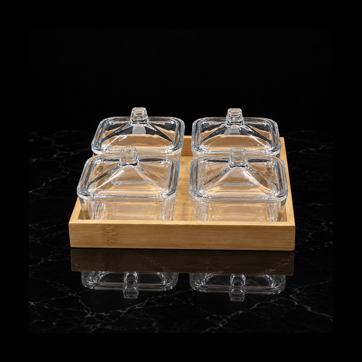 Glass lidded dish set with bamboo tray on black marble