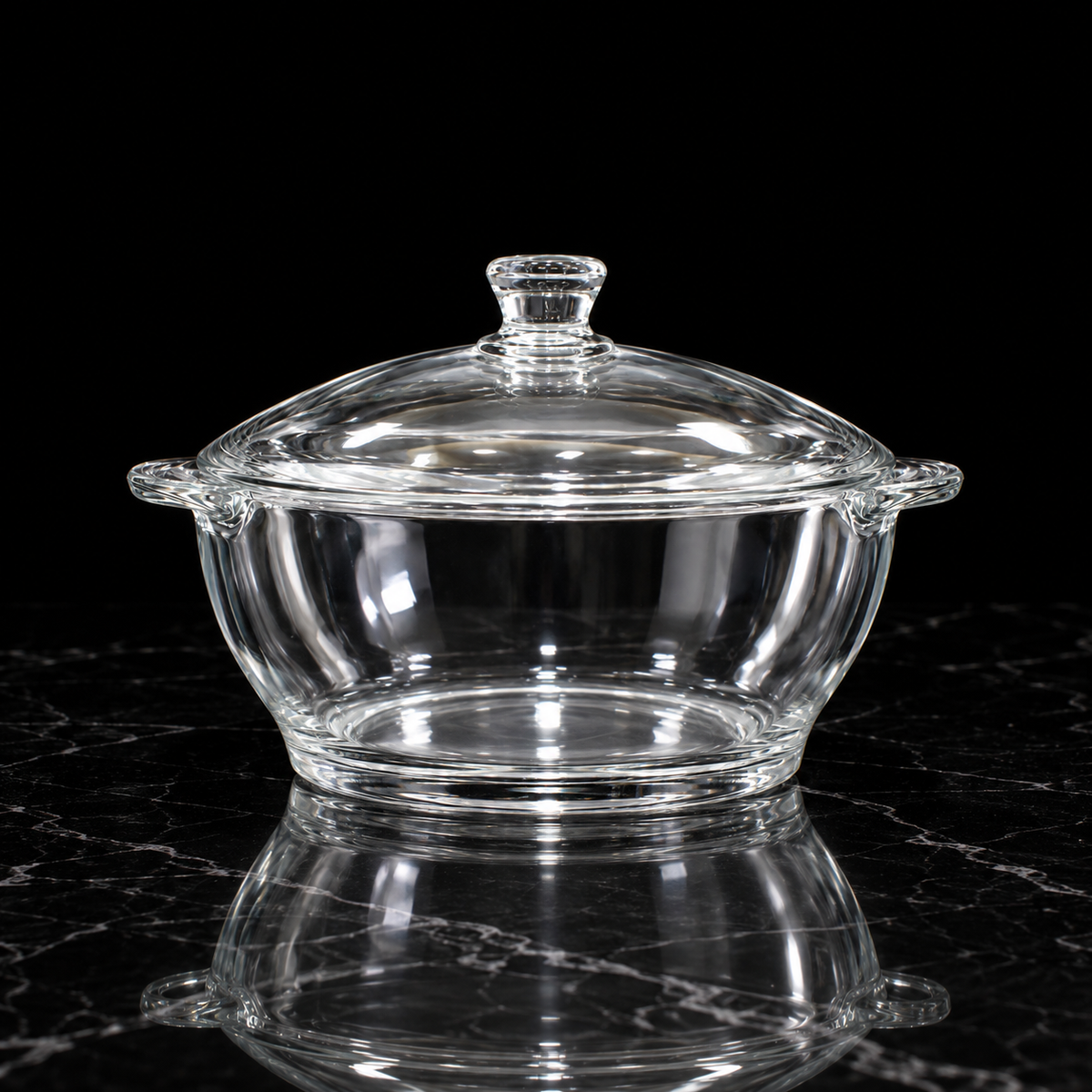 Glass casserole with lid on black marble
