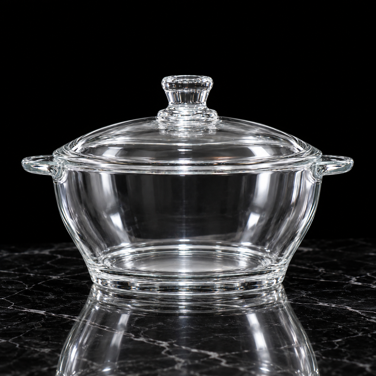 Glass casserole with lid on black marble