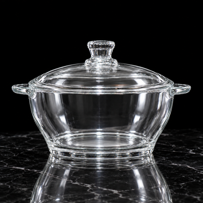 Glass casserole with lid on black marble