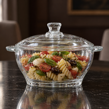 Glass casserole filled with pasta salad on a dining table