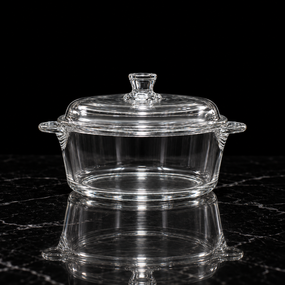 Glass casserole with lid on black marble