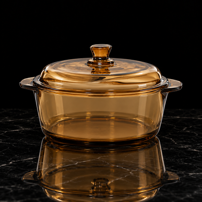 Amber glass casserole with lid on black marble