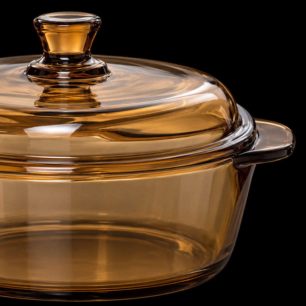 Close-up of amber glass casserole lid knob and handle