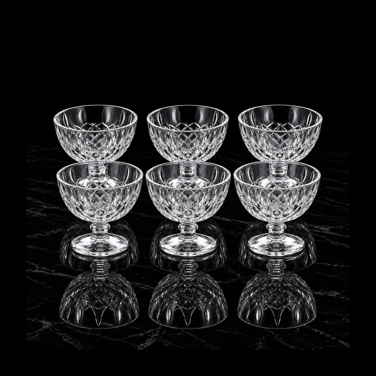 Six glass dessert bowls on black marble