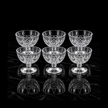 Six glass dessert bowls on black marble