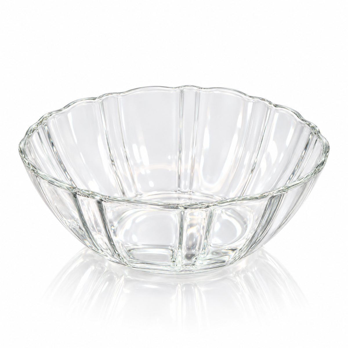 Fluted clear glass bowl with scalloped rim on white