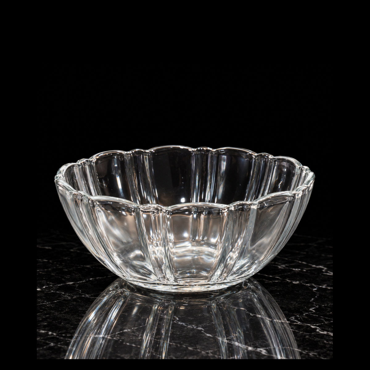 Fluted glass bowl on black marble