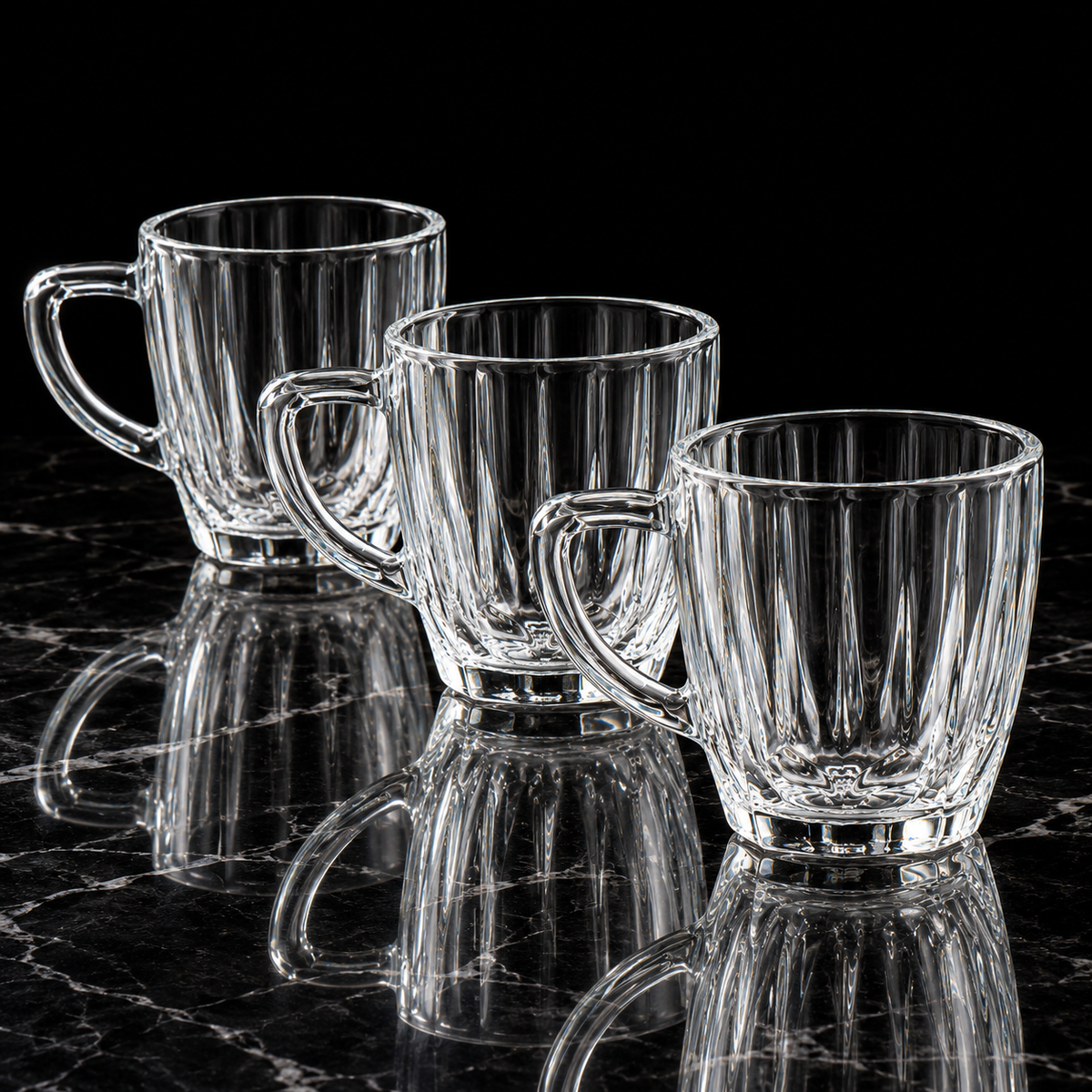 Glass tea cup with handle on black marble