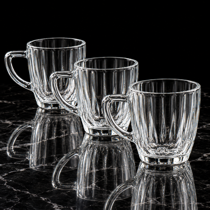 Glass tea cup with handle on black marble