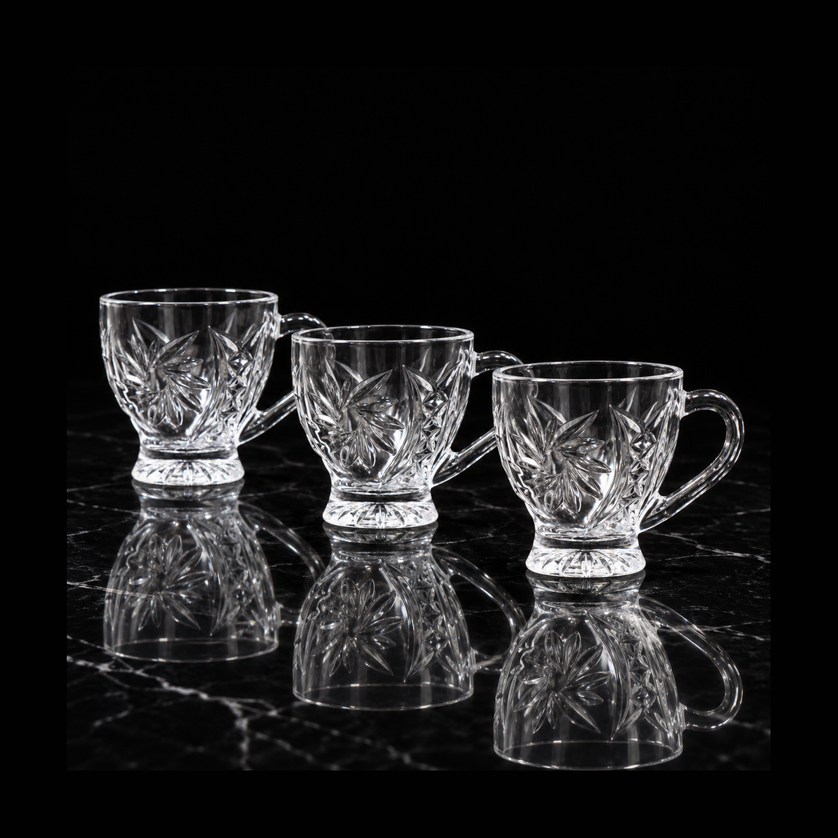 Glass tea cups on black marble