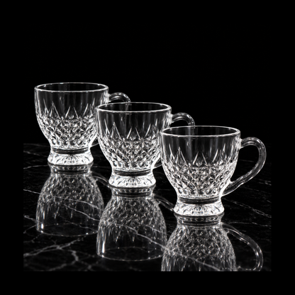 Diamond-cut glass tea cups on black marble