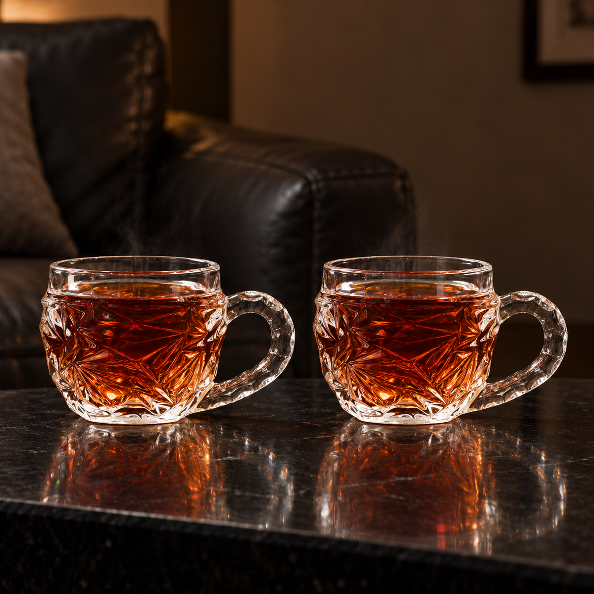 Two glass tea cups with hot tea in a living room