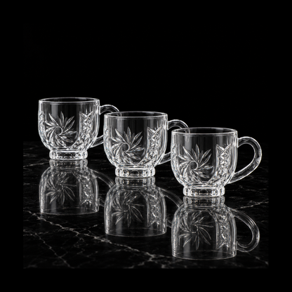 Pinwheel-cut glass tea cups on black marble