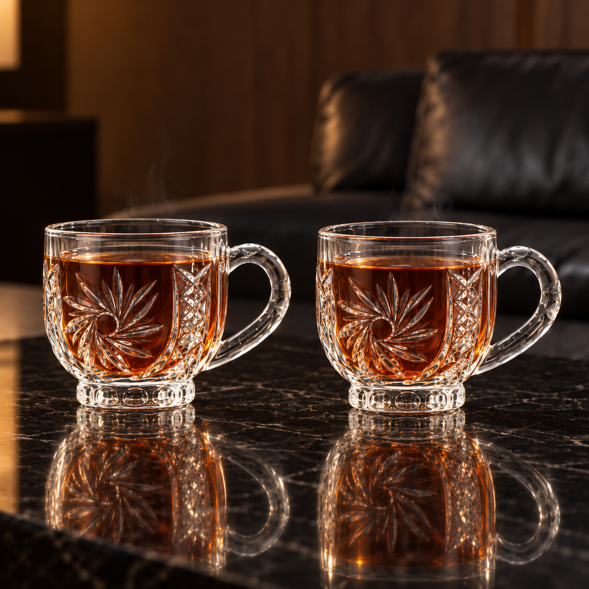Two glass tea cups with hot tea in a living room