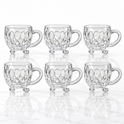 Set of 6 footed diamond-cut glass tea cups on white marble