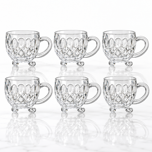 Set of 6 footed diamond-cut glass tea cups on white marble