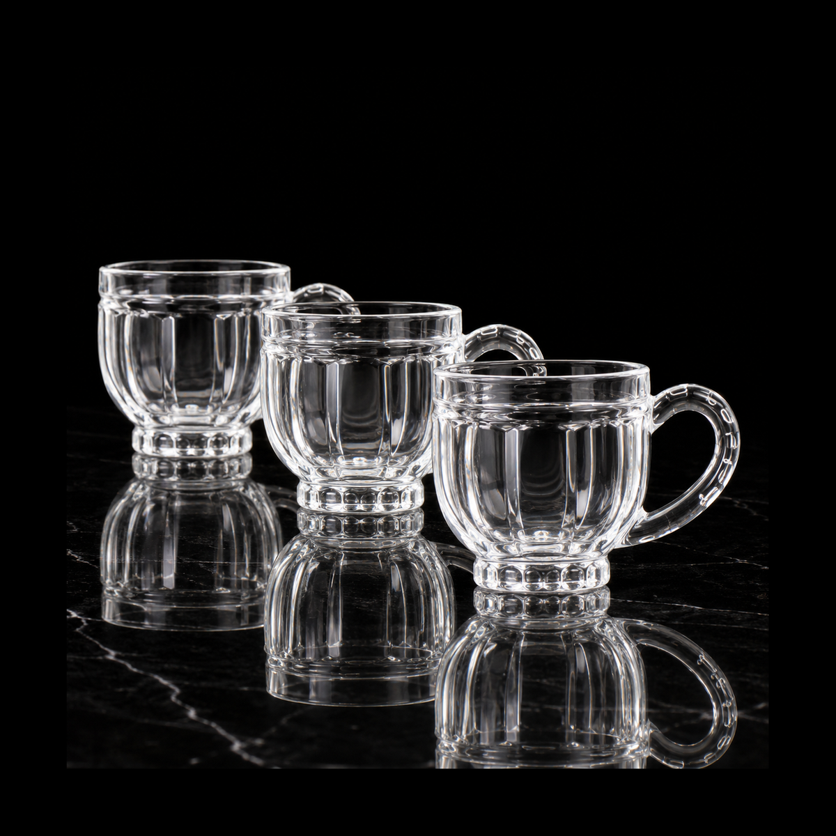 Paneled glass tea cups on black marble