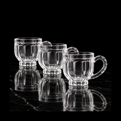 Paneled glass tea cups on black marble