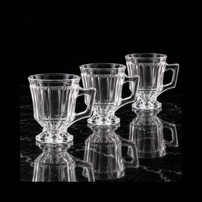Pedestal glass tea cups on black marble