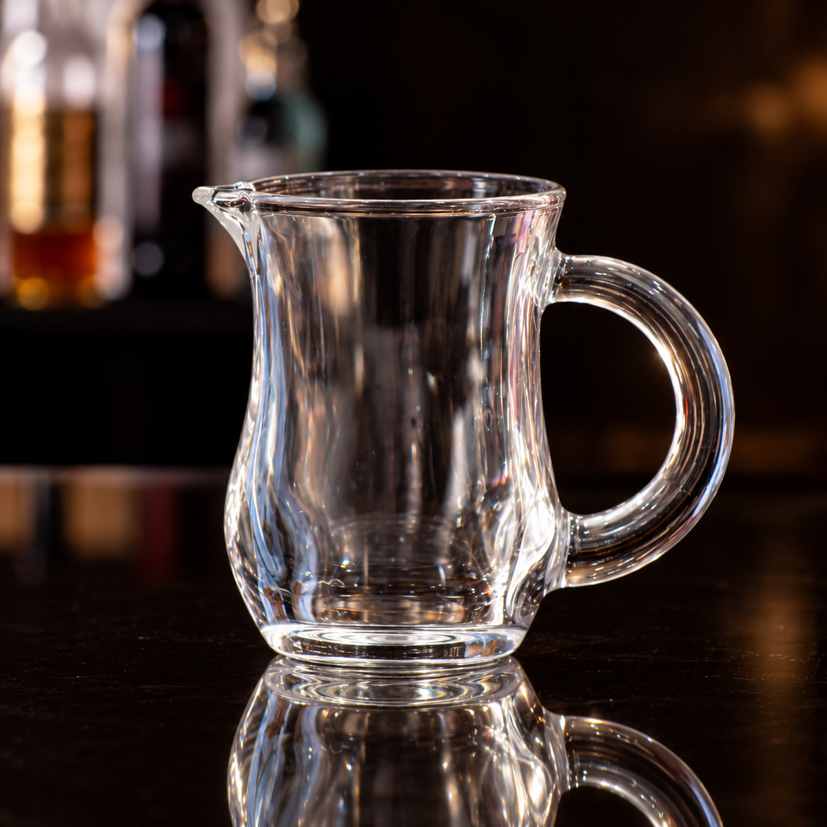 C-130 clear glass tea cup on a dark reflective surface