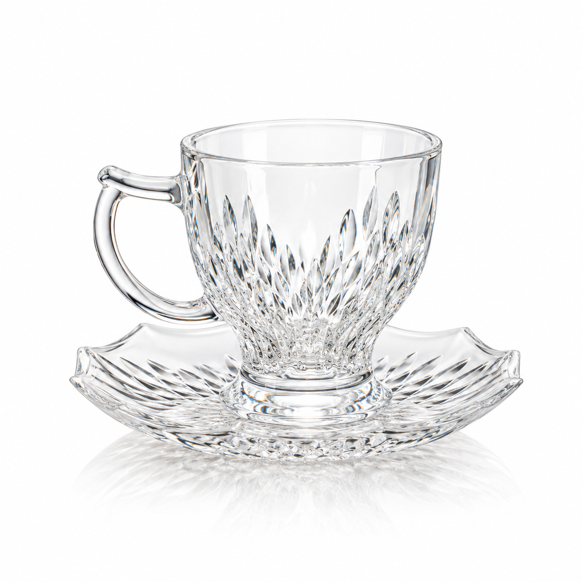 Leaf cut glass tea cup and scalloped saucer on white