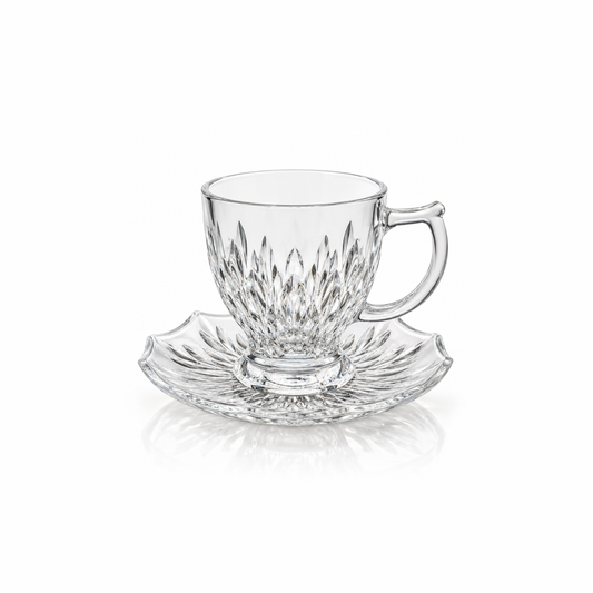 Leaf cut glass tea cup and scalloped saucer on white
