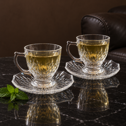 Two glass tea cups with green tea in a living room