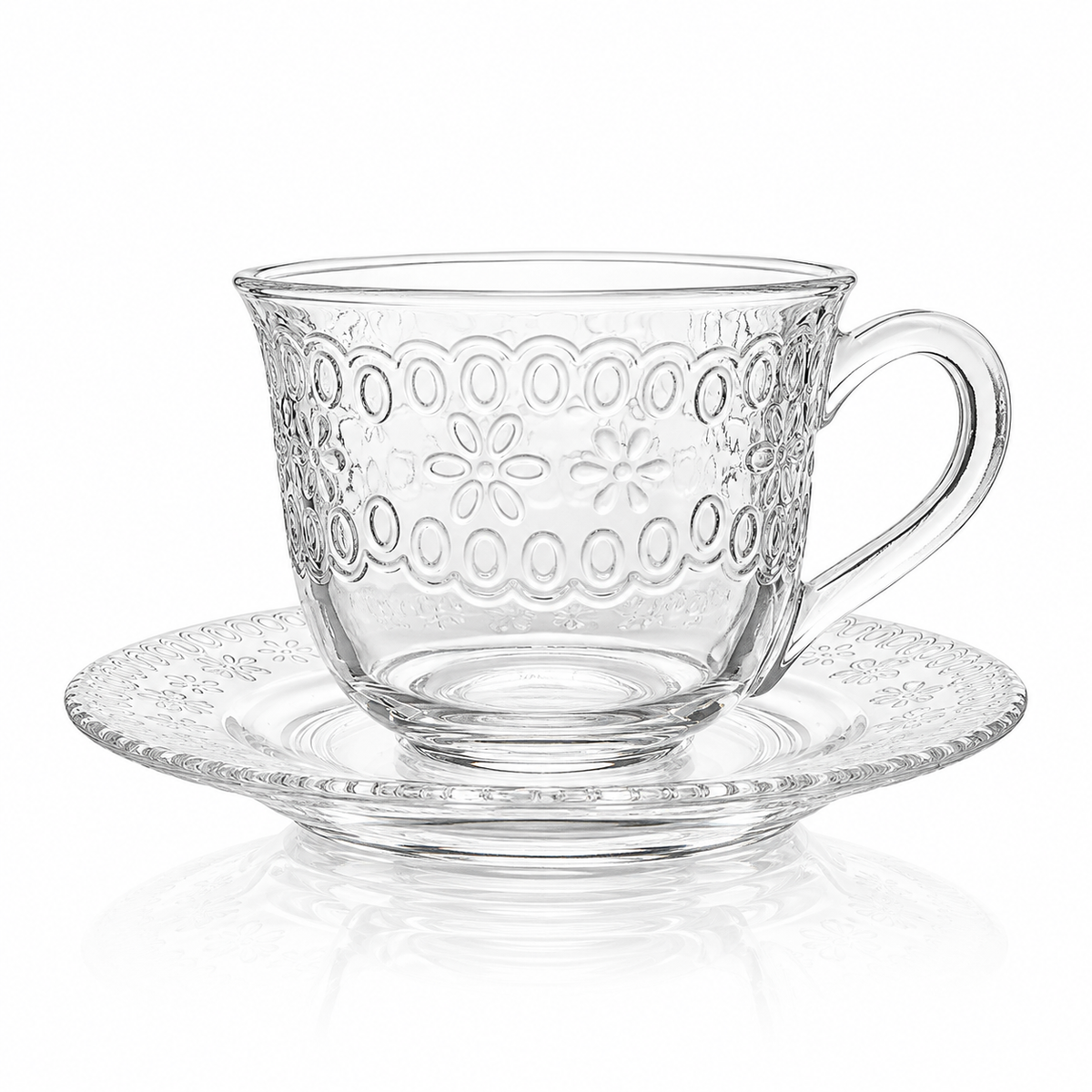 Embossed floral glass tea cup and saucer on white