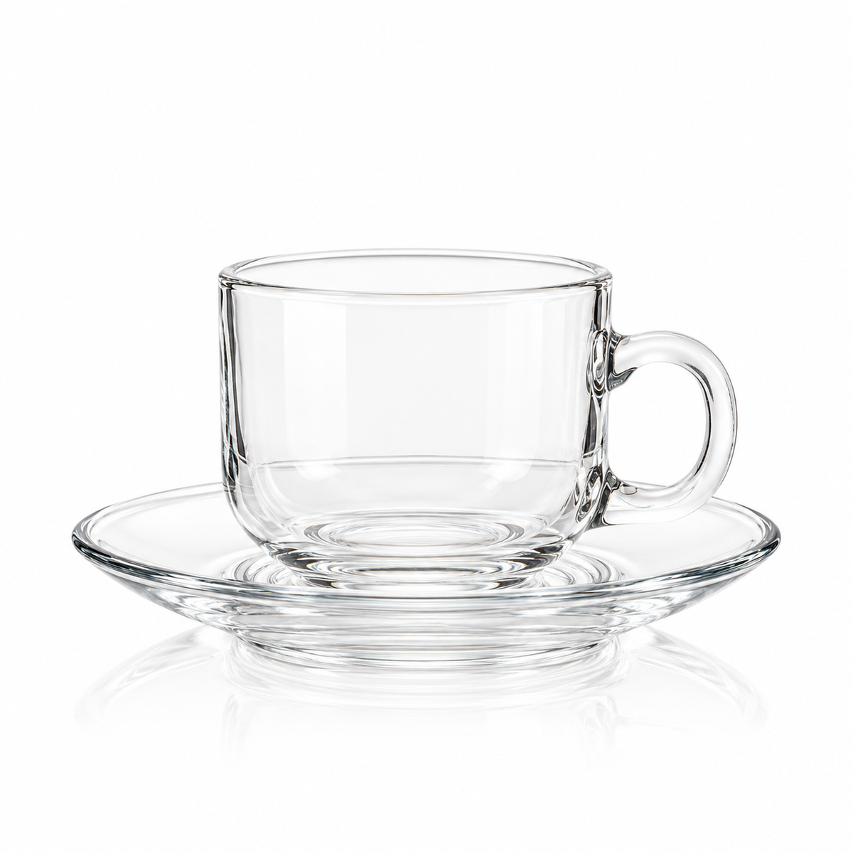 Clear glass tea cup and saucer on white