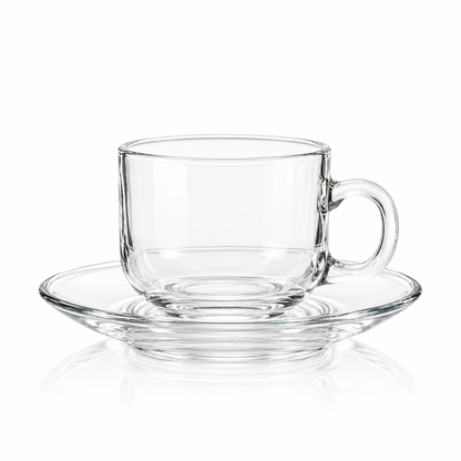 Clear glass tea cup and saucer on white
