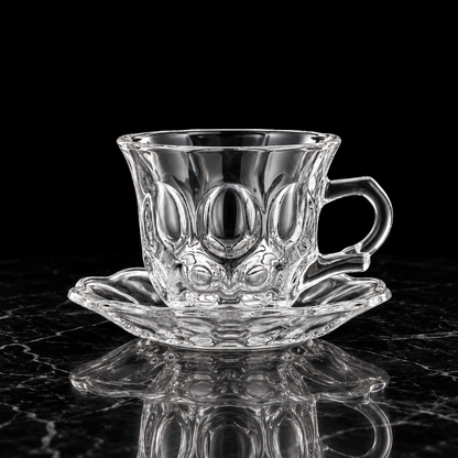 Oval bubble glass tea cup and saucer on black marble