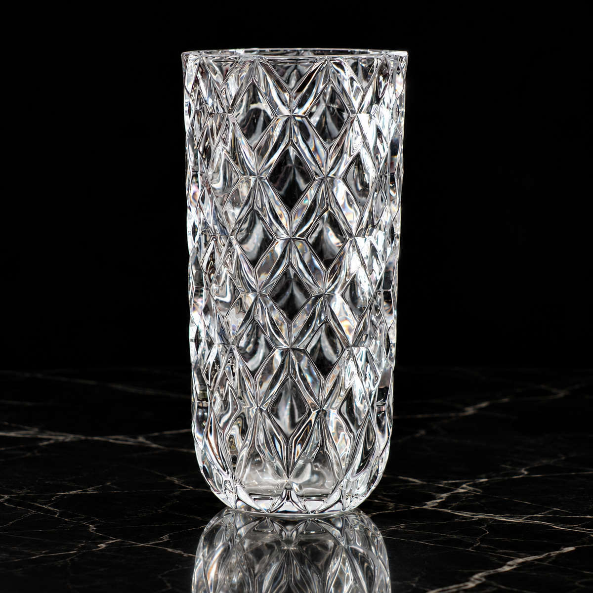 Crystal diamond-cut flower vase on black marble