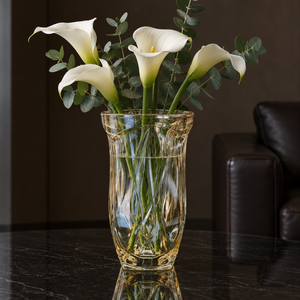 Crystal vase with calla lilies in a living room