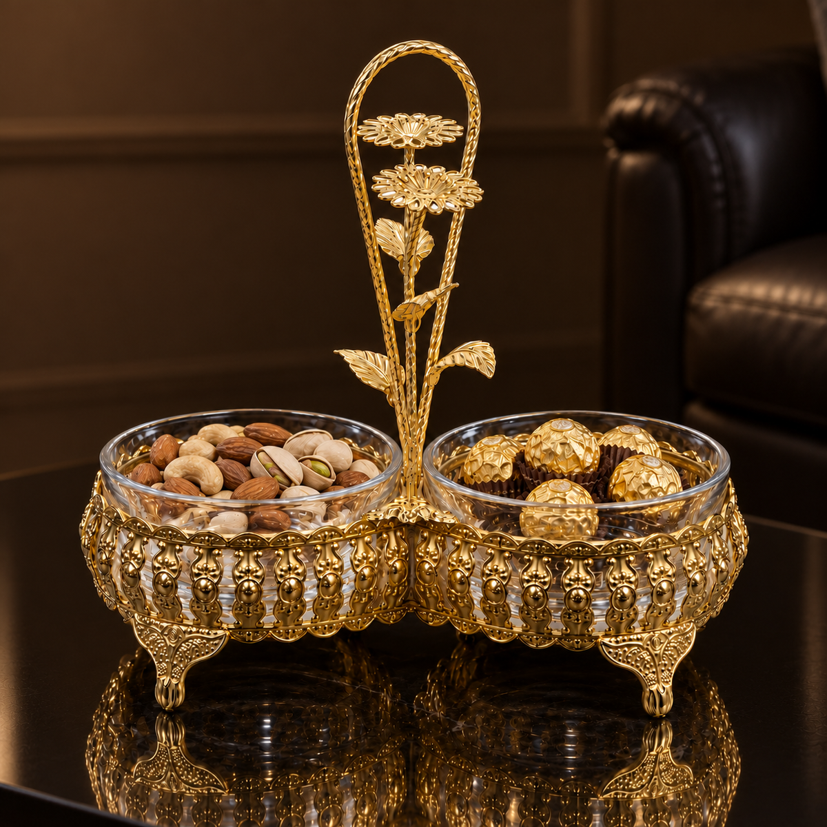 Gold double dish with nuts and chocolates on a black table