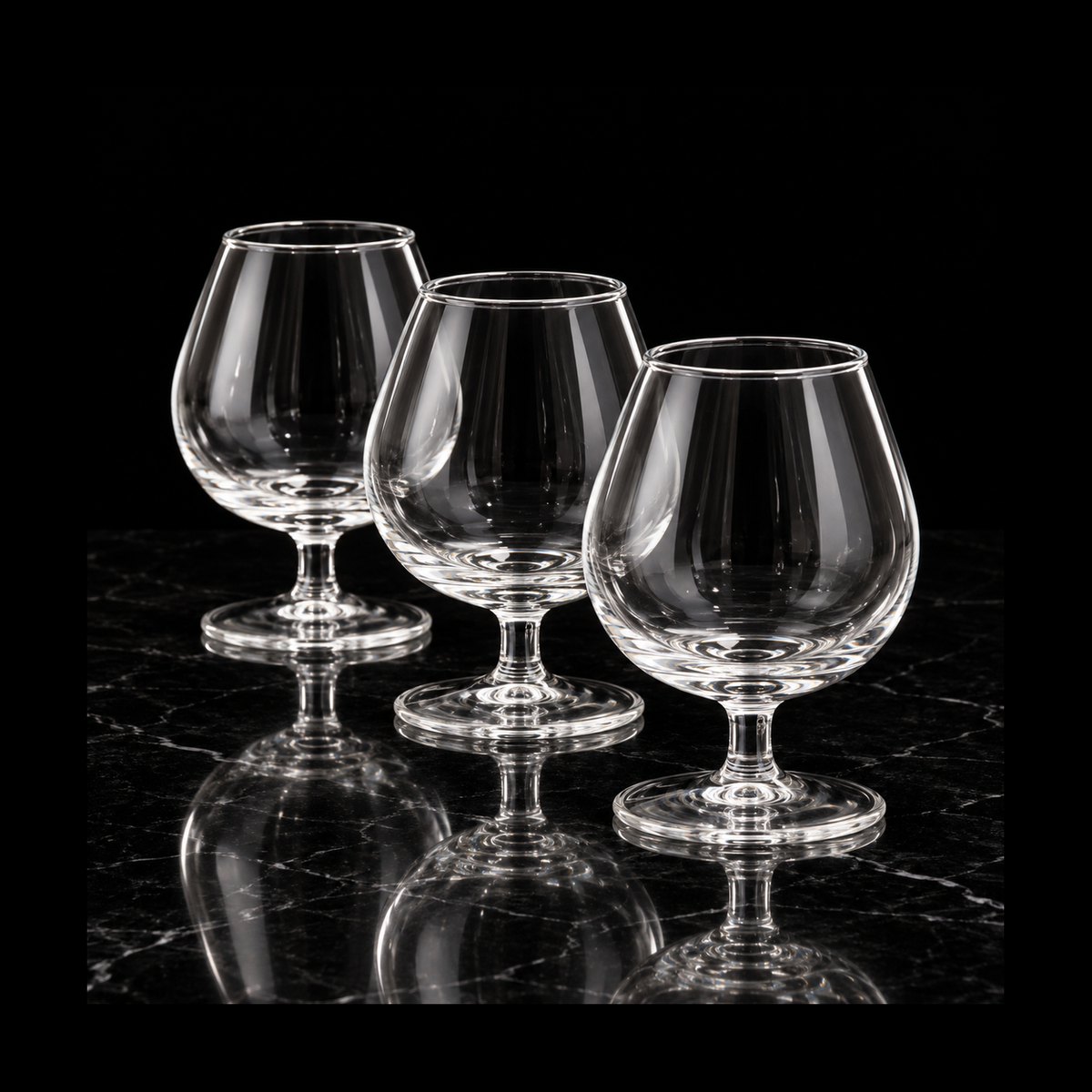 Glass snifters on black marble