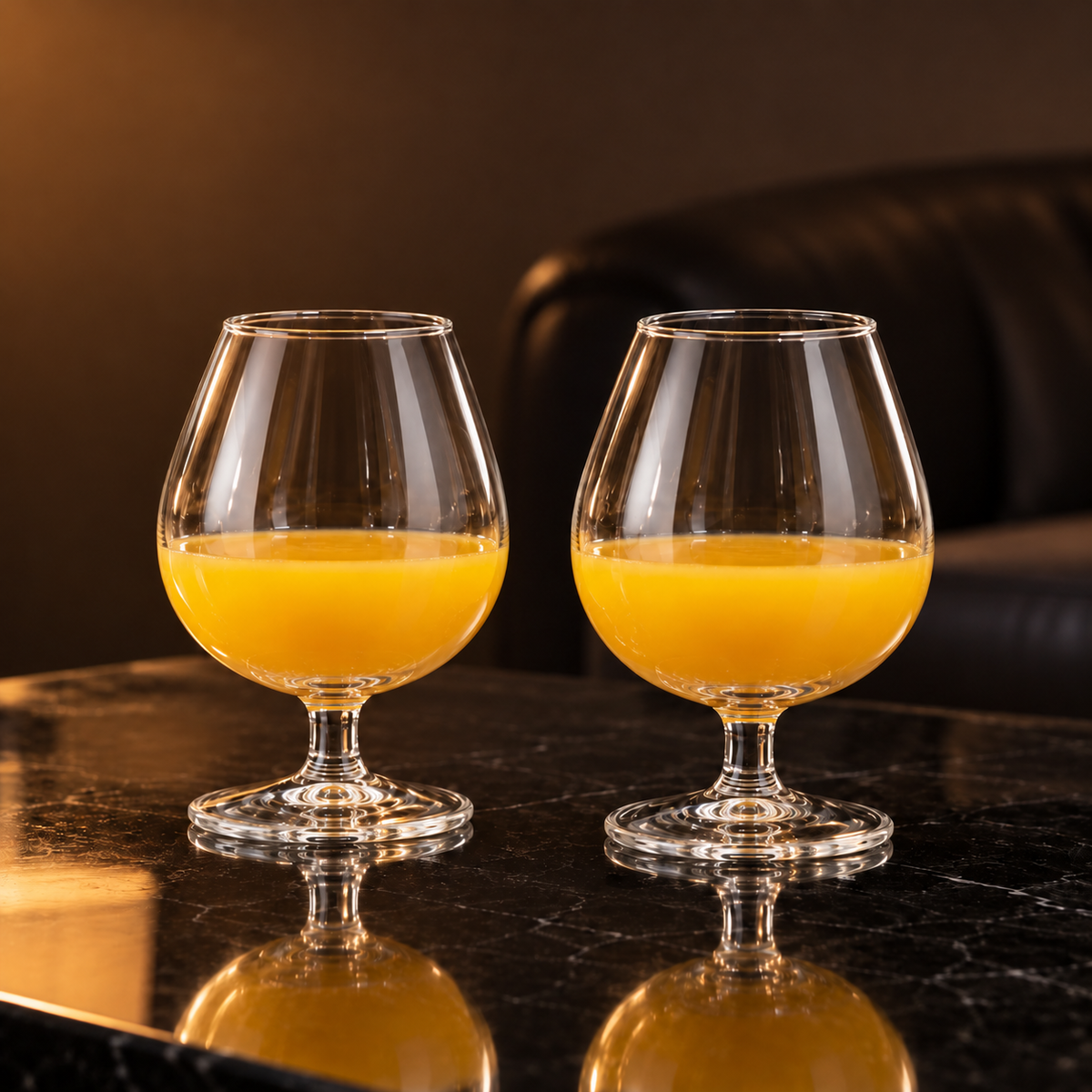 Snifters with mango juice in a living room