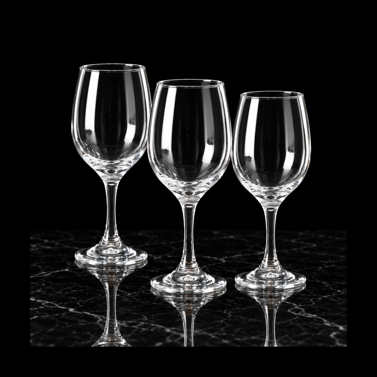 Clear wine glasses on black marble