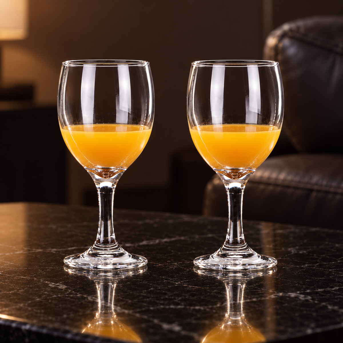 Wine goblets with orange juice in a living room