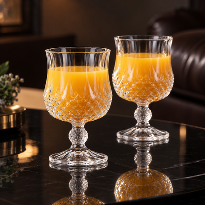 Crystal goblets with orange juice in living room