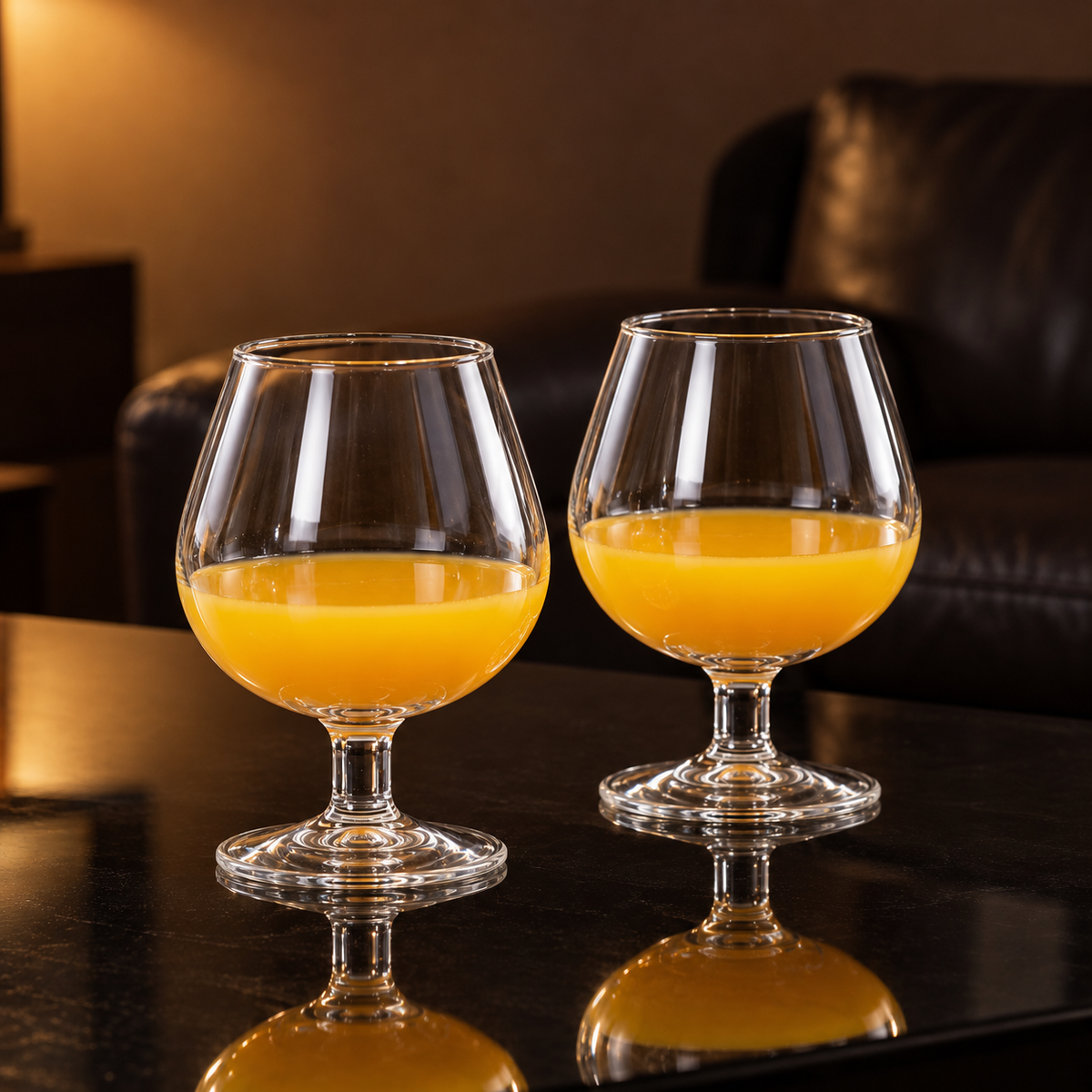 Glass snifters with orange juice in a living room