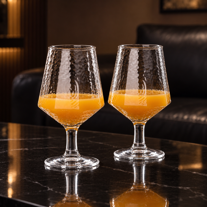 Hammered goblets with orange juice in a living room
